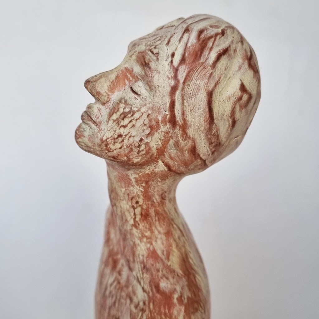 Ceramic figurative sculpture of woman praying. Red clay with pale yellow slip, carved and burnished pottery art