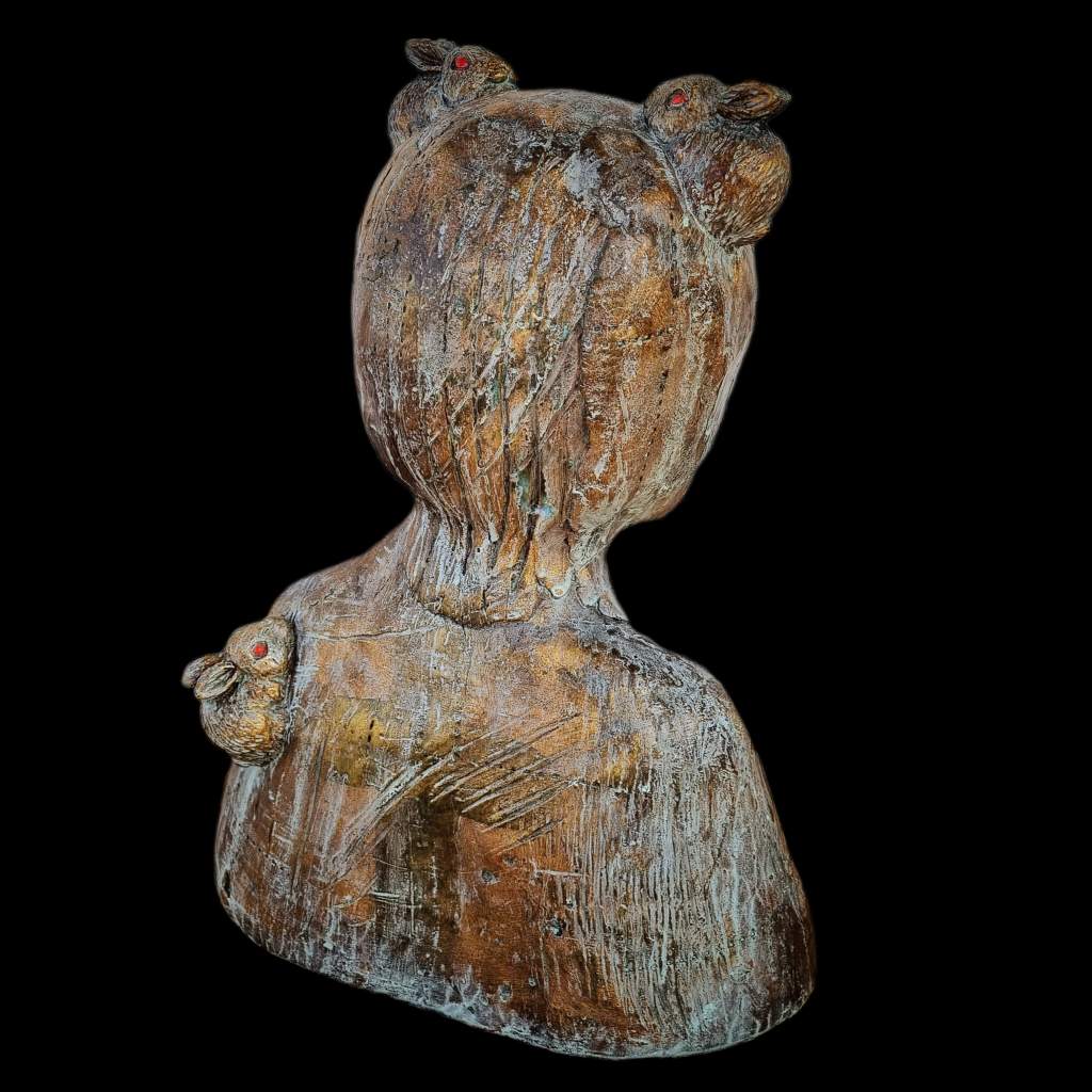 Back view of ceramic bronze statue with rabbits on black background